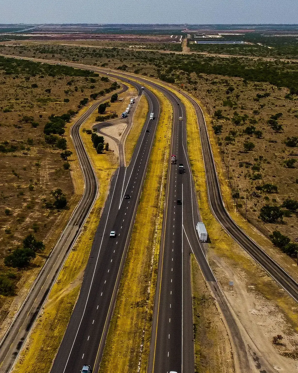 A highway cutting through the dry landscape around Midland, Texas, from the air